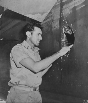 Zamperini inspects his damaged B-24 bomber