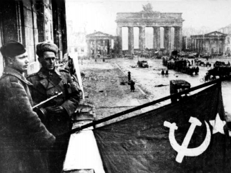Soldiers hoist the Soviet flag over Berlin