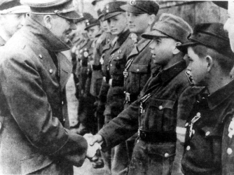Hitler awards the Iron Cross to members of the Hitler Youth on April 20, 1945.