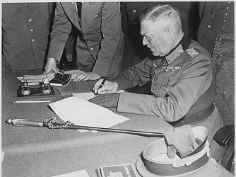 Field Marshall Wilhelm Keitel signing the German surrender terms on May 7, 1945.