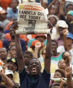A Sowetan holds up a newspaper announcing Mandela's release. (Credit: Trevor Samson/AFP/Getty Images)