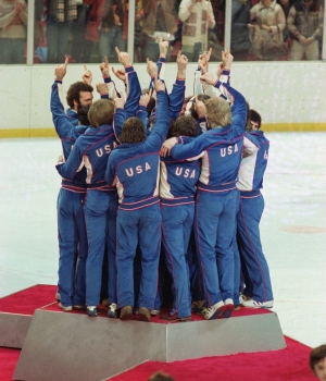 Team USA celebrates on the medal podium after winning the gold with a victory over Finland on February 24, 1980. (Credit: Robert Riger/Getty Images)