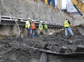 Workers excavating ship from WTC construction site (Credit: Lower Manhattan Development Corporation)