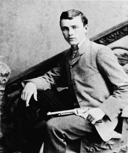 Portrait of American assassin Robert Ford showing off the revolver he used to kill outlaw Jesse James in 1882. (Credit: Authenticated News/Getty Images)