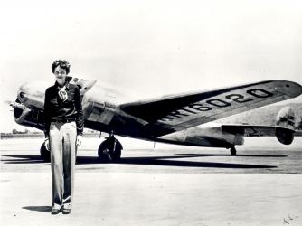 Amelia Earhart standing in front of the Lockheed Electra. (Credit: SSPL/Getty Images)