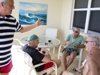 From the left, Bob Falk, Tom Hanks, Bob DeVenezia and Dennis Puleo sit and share stories on the balcony of the condo the group rented for a few days on Cinnamon Beach. (Credit: Naples Daily News)