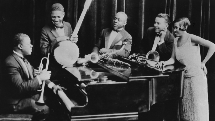 Louis Armstrong and his Hot Five band—his then-wife Lil is on the right. (Credit: Gilles Petard/Redferns)