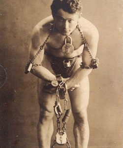 Houdini in chains during a stunt.
