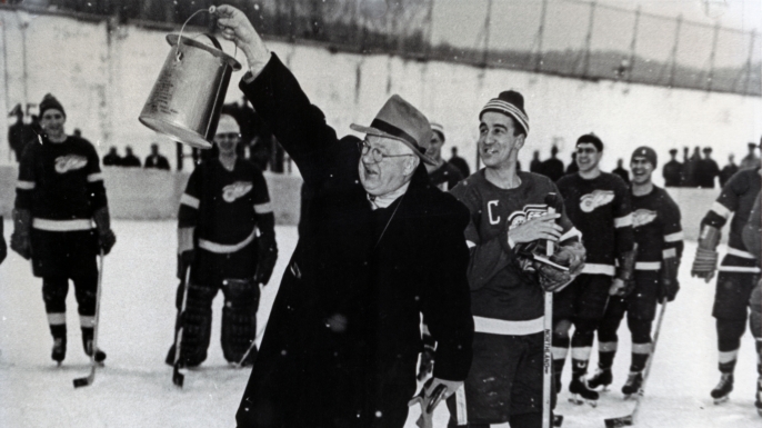 Detroit General Manager Jack Adams with a makeshift trophy given to the game's winner. (Credit: Detroit Red Wings)