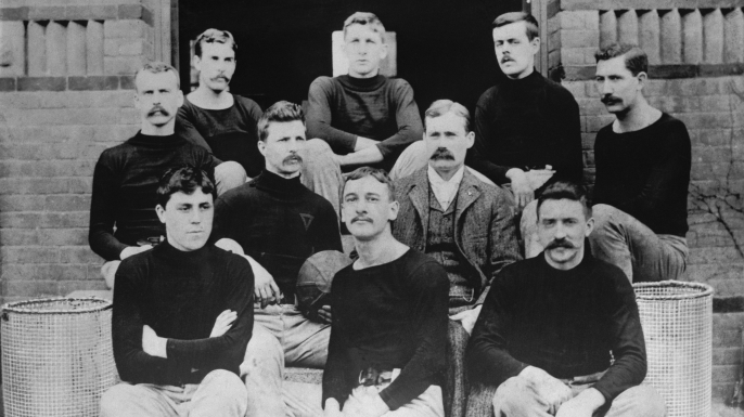 The first basketball team, consisting of nine players and their coach on the steps of the Springfield College Gymnasium in 1891 are shown. Dr. Naismith is in civilian clothes. (Credit: Bettmann/Getty Images)