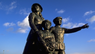 Statue of Annie Moore and her brothers, the first of 17 million Irish to be processed at Ellis Island. (Credit: Jan Butchofsky/Getty Images)