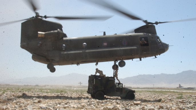U.S. Army soldiers prepare a Humvee to be sling-loaded by a CH-47 Chinook helicopter in Bagram, Afghanistan, on July 24, 2004. (Credit: Public Domain)