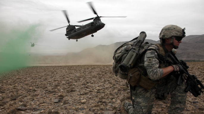U.S. Army Spc. Kevin Welsh provides security before boarding a CH-47 Chinook helicopter after completing a mission in Chak valley in the Wardak province of Afghanistan on Aug. 3, 2010. (Credit: Public Domain)