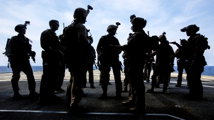 U.S. Marines and Navy SEALs debrief during a joint visit, board, search and seizure exercise as part of composite training in the Atlantic Ocean, July 20, 2015. (Credit: Cpl. Andre Dakis/26th MEU Combat Camera/Released)