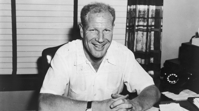 Baseball executive Bill Veeck (1914-1986) seated at his desk, 1965.