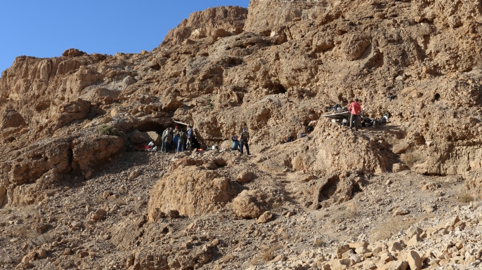 The fault cliff, with the cave entrance on the left