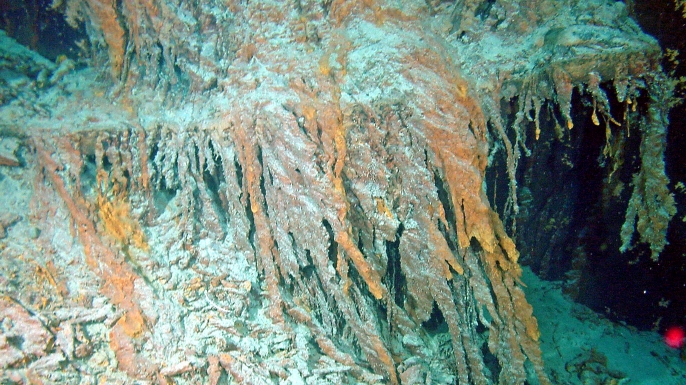 Window frames belonging to the Titanic. Rusticles are growing on either side of the window frames. (Credit: Public Domain)