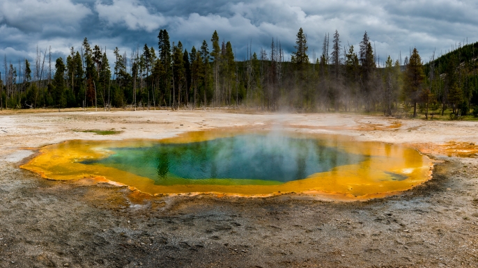 The pools steam and bubble of the supervolcano in Yellowstone National Park, Wyoming, United States. (Credit: Russell Pearson/Barcroft Images/Getty Images)