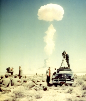 CBS newsreel cameraman and troops watching the atomic bomb test explosion on April 22, 1952.