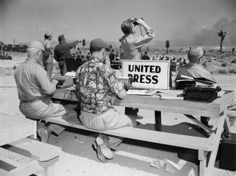 UPI correspondents working at the test site.