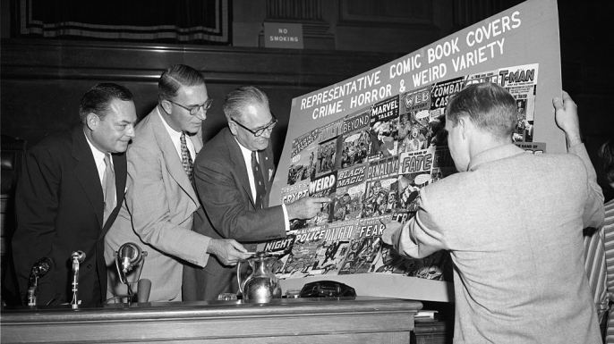 Senators Thomas D. Hennings, Estes Kefauver, Robert C. Hendrickson and Ricard Clendenen, look over sample covers of comic books at a New York hearing of a Senate sub-committee.