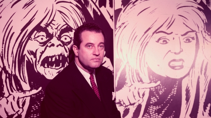 Charles F. Murphy, poses in front of two illustrations showing the changes in a comic strip character due to the comic book code.