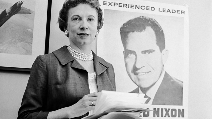 Rose Mary Woods stands in front of a poster for her boss during the 1960 presidential election.