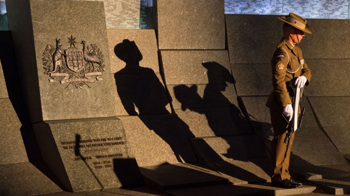 An Australian soldier stands at the Australian War Memorial during an Anzac Day dawn service at Hyde Park Corner in London on April 25. (Credit: DOMINIC LIPINSKI/AFP/Getty Images)