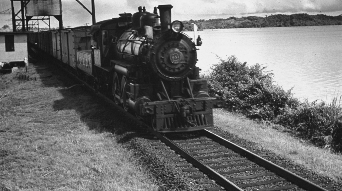 Railroad train following tracks beside Panama Canal. (Credit: Thomas D. Mcavoy/The LIFE Picture Collection/Getty Images)