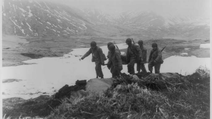 U.S. troops carrying a stretcher on Attu