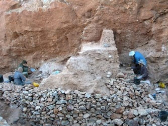 Excavators working on the remaining deposits at Jebel Irhoud (Morocco). The new fossils were found in the sediments in front of where the two excavators on the left are working (Credit: Shannon McPherron, MPI EVA Leipzig, License: CC-BY-SA 2.0).
