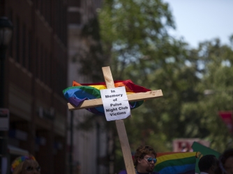 A cross with a sign in memory of the victims of the Pulse nightclub shooting carried during the 2016 Gay Pride Parade on June 12, 2016 in Philadelphia. (Credit: Jessica Kourkounis/Getty Images)