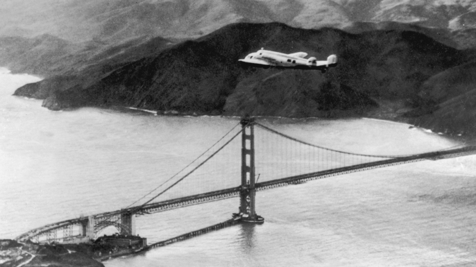 The Lockheed Electra 'Flying Laboratory', piloted by American aviator Amelia Earhart and Fred Noonan, over the Golden Gate bridge in California, at the start of a planned round-the-world flight. (Credit: Keystone/Hulton Archive/Getty Images)