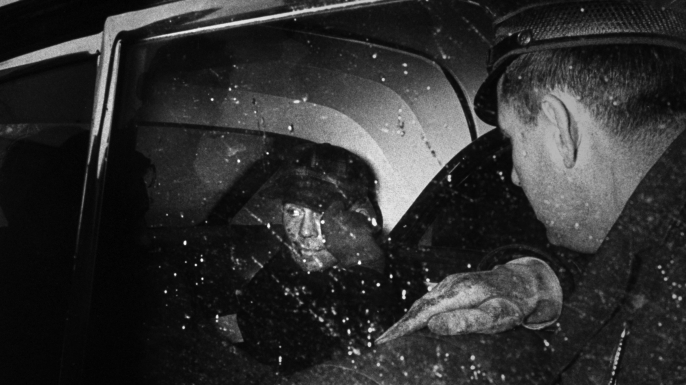 Serial Killer Ed Gein sitting in back of police car after being arrested. He supposedly murdered 11 people, eviscerating them and hiding body parts in his house. (Credit: Frank Scherschel/The LIFE Picture Collection/Getty Images)