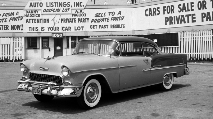 Two-tone 1955 Chevrolet Bel Air with whitewall tires in a used-car lot. (Credit: Eric Rickman/The Enthusiast Network/Getty Images)