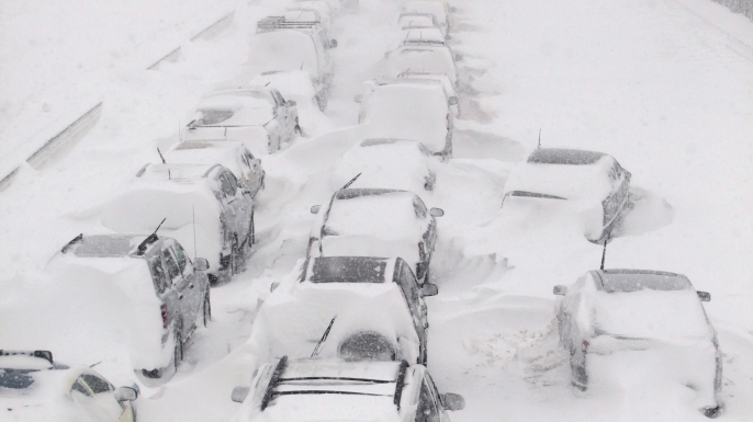 Hundreds of cars seen stranded on Lake Shore Drive during a massive winter blizzard in Chicago that left motorists sitting in their cars for hours or had them trudging through the snow to safety. (Credit: Kiichiro Sato/AP Photo)