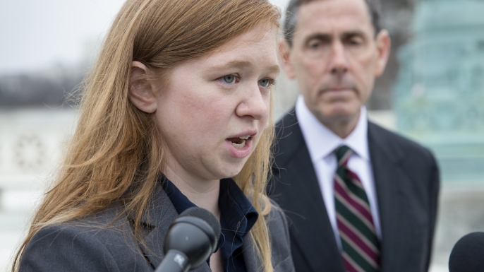 Abigail Fisher, who challenged the use of race in college admissions, joined by lawyer Edward Blum, speaks to reporters outside the Supreme Court in Washingston. (Credit: J. Scott Applewhite/AP Photo)