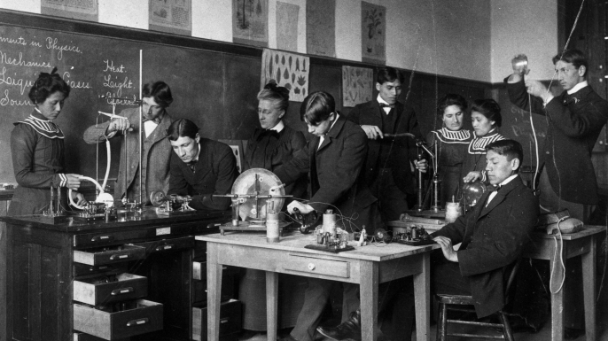 Native-American students and their teacher conduct physics experiments at the Carlisle Indian School in Carlisle, Pennsylvania, 1915. (Credit: PhotoQuest/Getty Images)