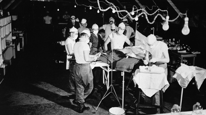 An operation is performed on a wounded soldier at the 8209th Mobile Army Surgical Hospital, twenty miles from the front lines of the Korean War on August 4, 1952. (Credit: Corbis via Getty Images)