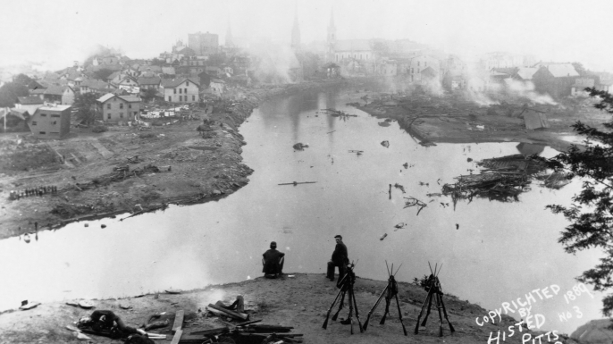 Soldiers sit on a hill overlooking Johnstown, Pennsylvania after the 1889 flood. (Credit: Histed/Library of Congress/Corbis/VCG via Getty Images)