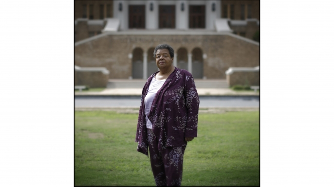 Elizabeth Eckford in front of the main entrance of Central High School in Little Rock, Arkansas, 2007. Eckford was the first of nine black schoolchildren to make history on September 4th, 1957 when she arrived, alone, for the first day of classes at the all-white high school. (Credit: Charles Ommanney/Getty Images)