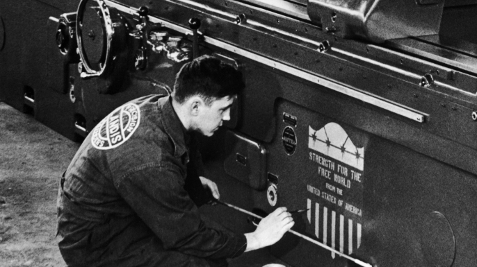 An American worker drawing the new logo of the Marshall Plan on a machine-tool ready to be exported to Europe. (Credit: Keystone-France/Gamma-Keystone via Getty Images)