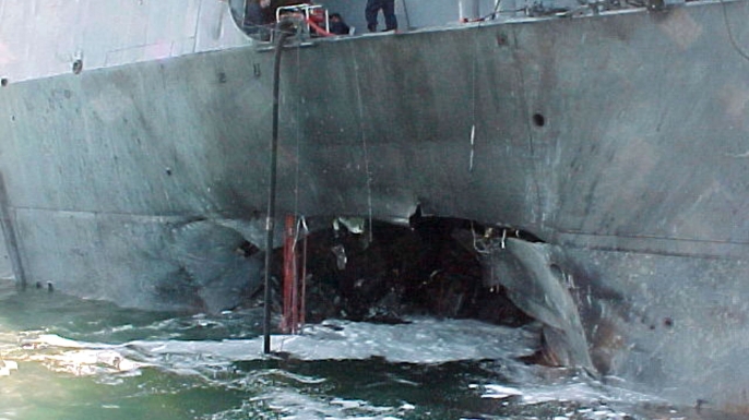 A gaping hole mars the port side of the USS Cole after a terrorist bomb exploded and killed 17 U.S. sailors and injured approximately 36 others on October 12, 2000, in the port of Aden, Yemen.