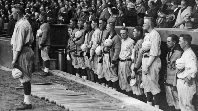 The New York Yankees hold their caps over their hearts during a performance of the national anthem, 1921. (Credit: FPG/Getty Images)