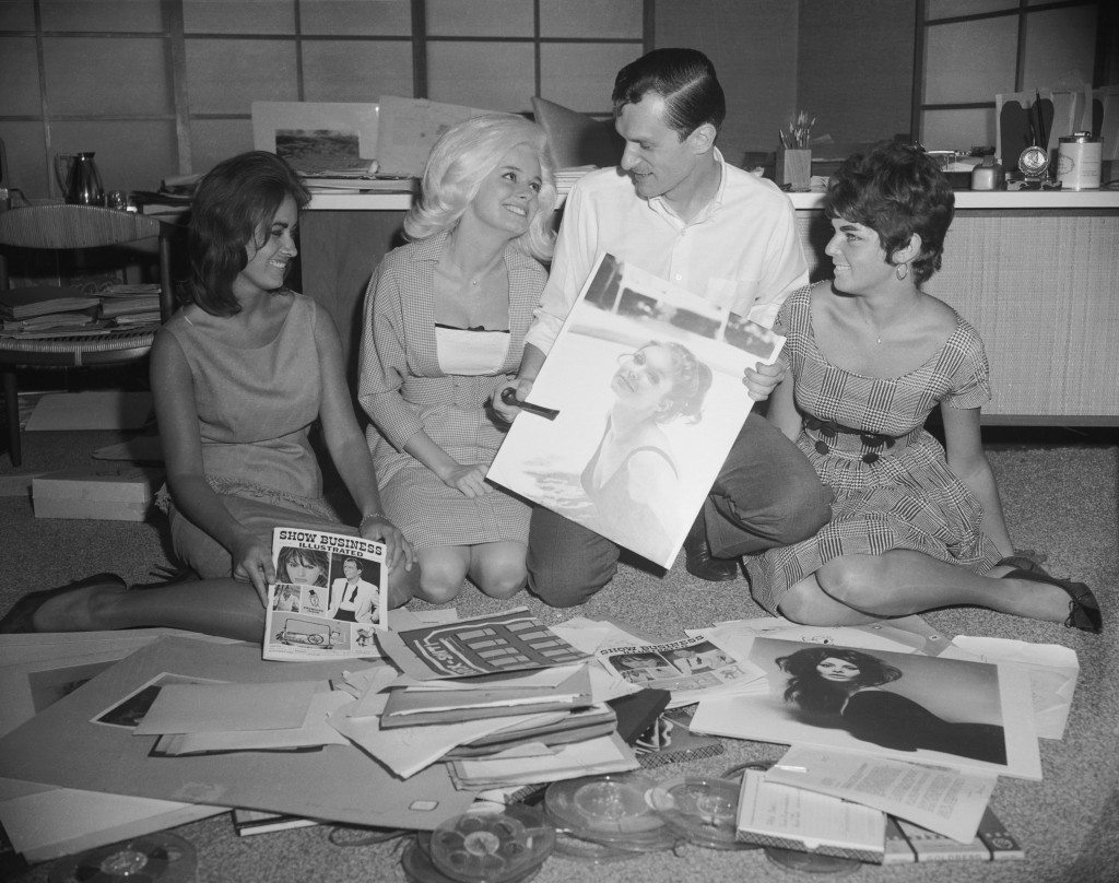 Playboy publisher Hugh Hefner working on image selection for publication. (Credit: Bettmann/Getty Images)