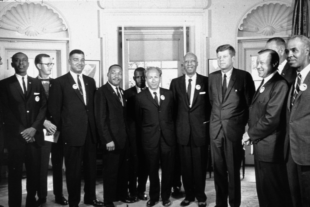 John Lewis stands to the left of Martin Luther King Jr. as President Kennedy meets with leaders of the March on Washington at the White House on August 28, 1963.(Photo by MPI/Getty Images)