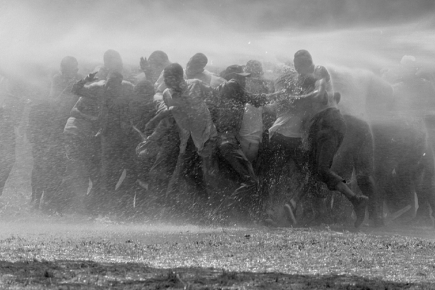 Civil rights foot soldiers are sprayed with high-powered water cannons to prevent them from protesting in Birmingham, Alabama. (Photo by John Duprey/NY Daily News Archive via Getty Images.)