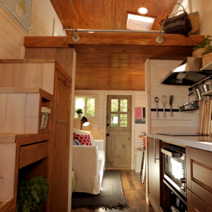 A staircase up to Kelsey's loft adds extra, and much needed, storage for the tiny house couple.
