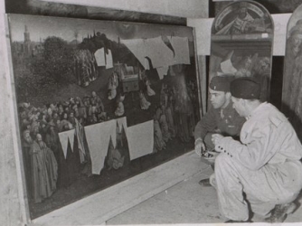 Members of the Monuments Men group examines part of the recovered Ghent Altarpiece.
