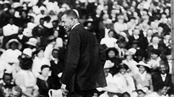 Booker T. Washington addressing a large crowd, circa 1910.